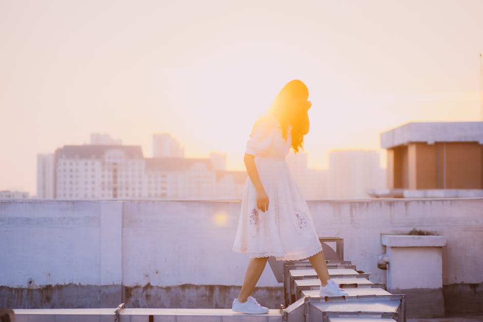 A Woman Walking on Rooftop Ducts